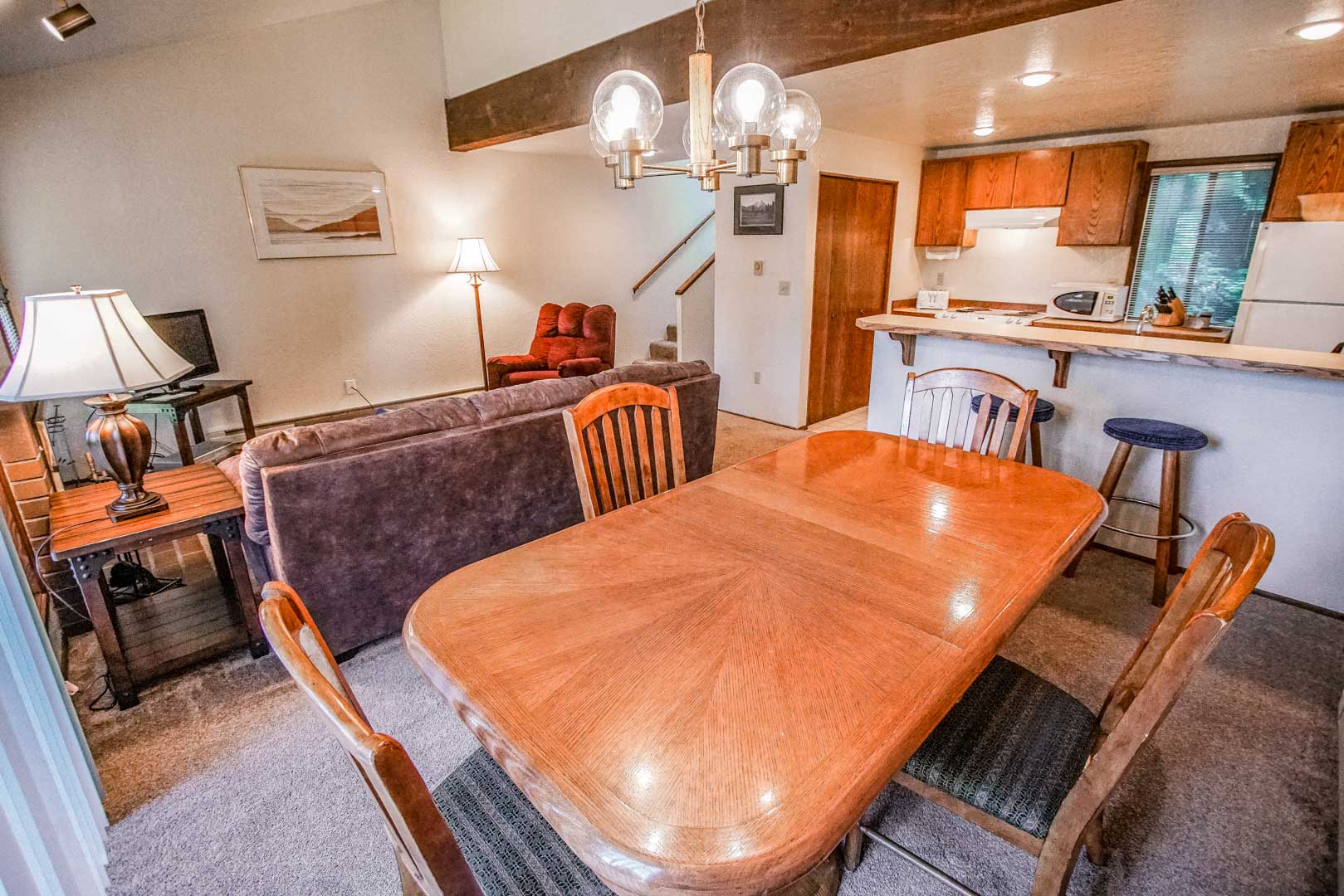 A spacious dining room table and living room at VRI's Kala Point Village in Port Townsend, Washington.